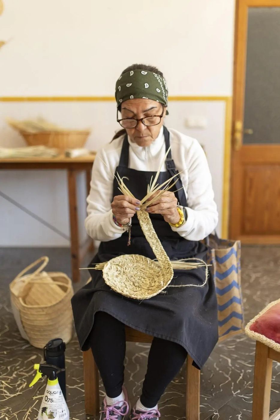 Blacksmith working in an apron in the workshop