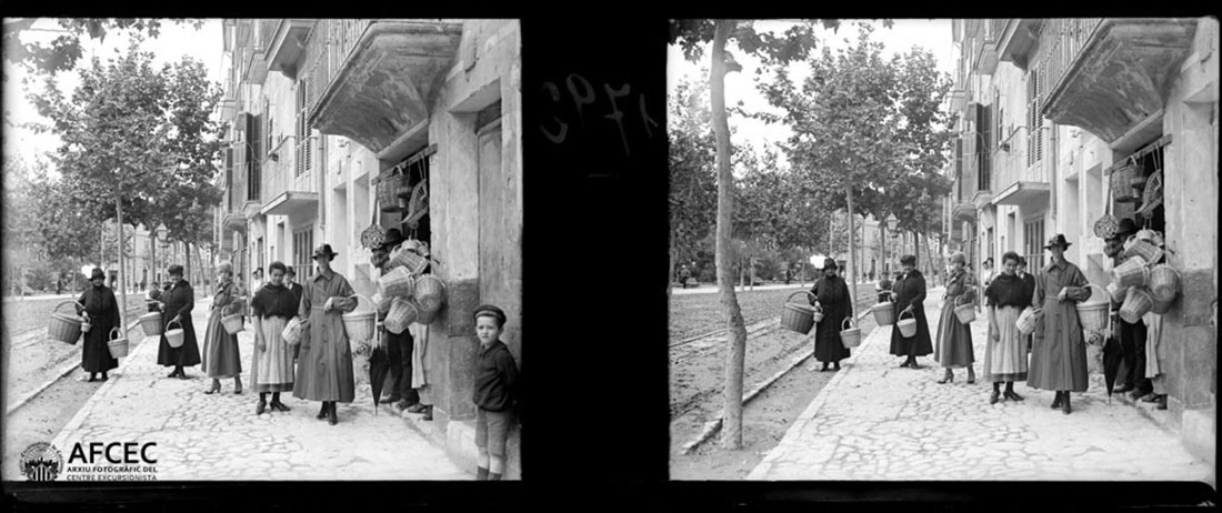 Women with baskets at the door of a basket shop in a street in Palma