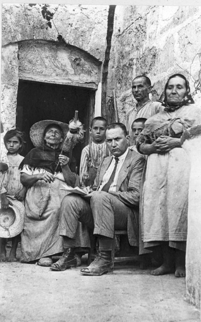 Group of people, among them a woman spinning